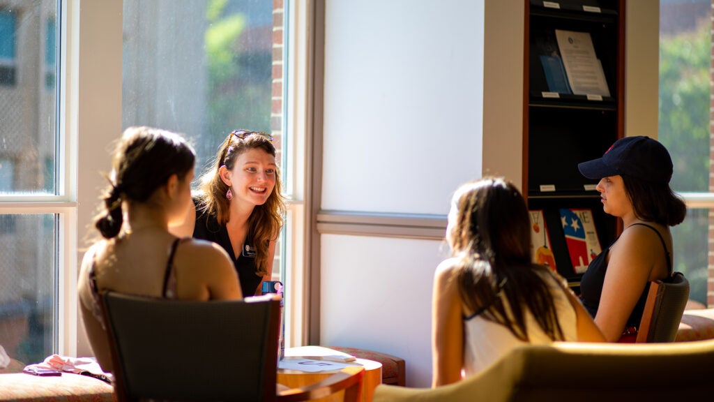 Undergraduate students sitting and talking in a circle